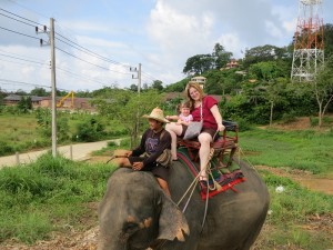 Libby and Emerson riding an elephant